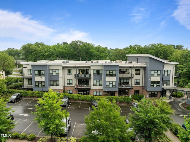 515 N Churton St Unit 203, Hillsborough, NC 27278 - view of property with uncovered parking and view of wooded area