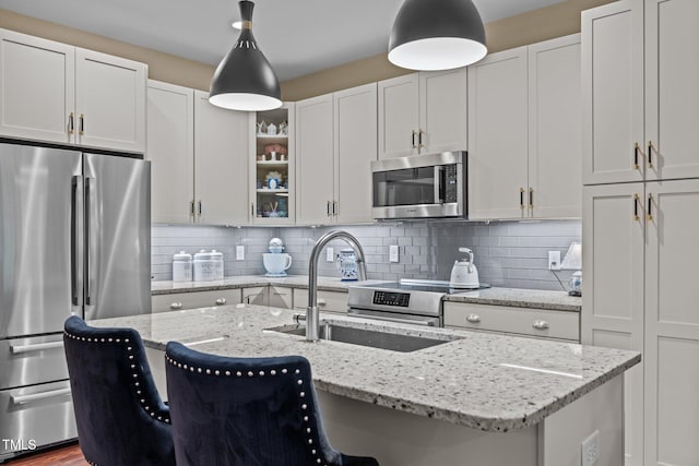 515 N Churton St Unit 203, Hillsborough, NC 27278 - kitchen featuring stainless steel appliances, a sink, pendant lighting, tasteful backsplash, and white cabinetry
