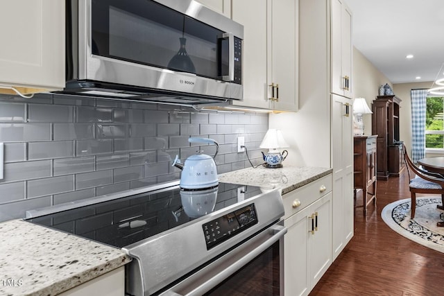 515 N Churton St Unit 203, Hillsborough, NC 27278 - kitchen featuring appliances with stainless steel finishes, white cabinets, dark wood-type flooring, backsplash, and light stone countertops