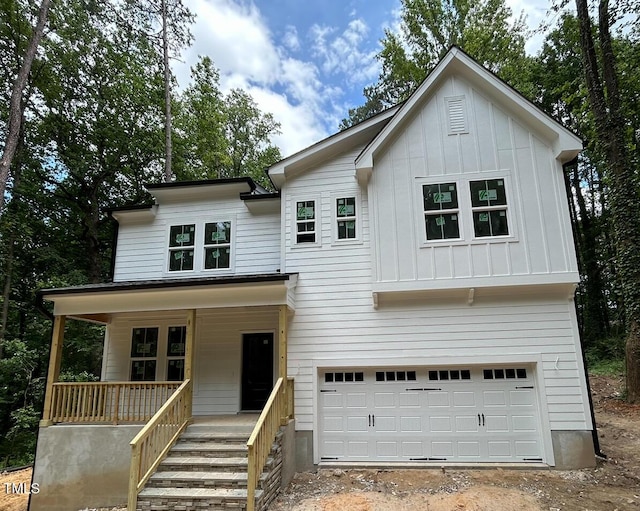 701 Locust Ln, Raleigh, NC 27603 - view of front facade with a porch, an attached garage, board and batten siding, and driveway