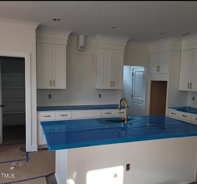 701 Locust Ln, Raleigh, NC 27603 - kitchen with a center island with sink, white cabinets, and dark countertops