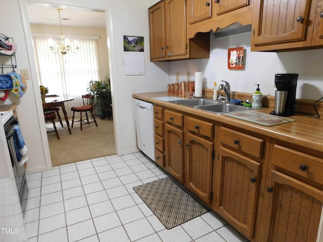 5009 Tower Rd Unit B, Greensboro, NC 27410 - kitchen featuring dishwasher, a sink, light carpet, brown cabinets, and a chandelier