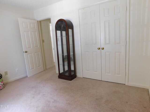 5009 Tower Rd Unit B, Greensboro, NC 27410 - unfurnished bedroom featuring carpet floors, a closet, and baseboards