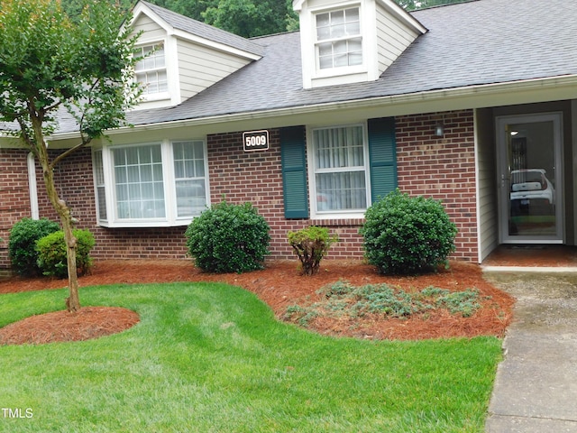 5009 Tower Rd Unit B, Greensboro, NC 27410 - cape cod-style house featuring brick siding, a front lawn, and roof with shingles