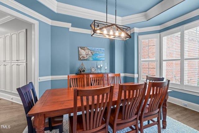 204 Franconia Way, Apex, NC 27502 - dining room with a chandelier, wood finished floors, crown molding, and a raised ceiling