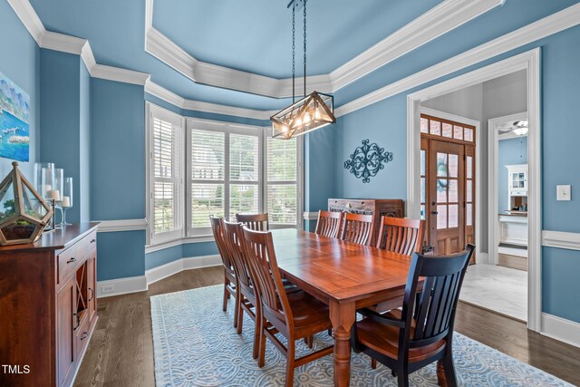 204 Franconia Way, Apex, NC 27502 - dining area featuring crown molding, french doors, dark wood-style flooring, a chandelier, and a tray ceiling