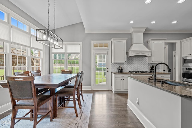 204 Franconia Way, Apex, NC 27502 - dining area featuring plenty of natural light, dark wood-style flooring, ornamental molding, recessed lighting, and vaulted ceiling