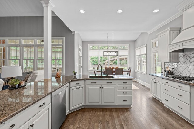 204 Franconia Way, Apex, NC 27502 - kitchen with appliances with stainless steel finishes, dark wood-style floors, tasteful backsplash, ornate columns, and white cabinetry