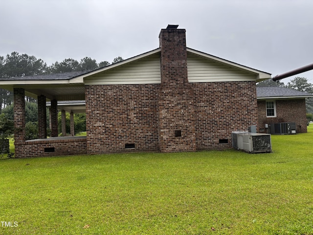 11477 NC-87, Elizabethtown, NC 28337 - view of property exterior with crawl space, a yard, brick siding, and a chimney