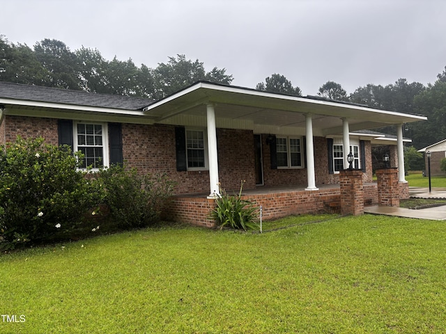 11477 NC-87, Elizabethtown, NC 28337 - view of front facade with a front lawn, covered porch, and brick siding