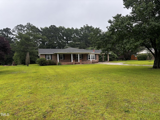 11477 NC-87, Elizabethtown, NC 28337 - single story home featuring a front yard, driveway, an attached carport, and brick siding