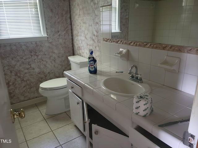 11477 NC-87, Elizabethtown, NC 28337 - bathroom with healthy amount of natural light, vanity, tile patterned floors, wallpapered walls, and tasteful backsplash
