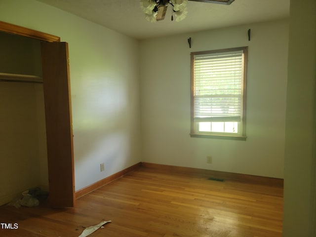 11477 NC-87, Elizabethtown, NC 28337 - unfurnished bedroom featuring light wood-style floors and a ceiling fan
