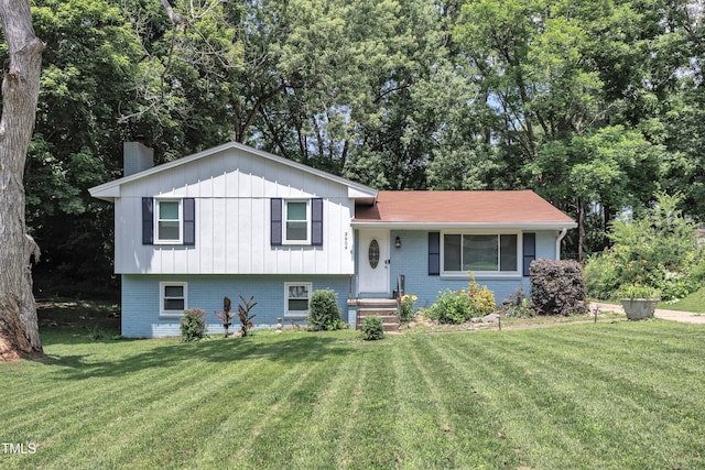 3509 Crofton Ct, Raleigh, NC 27604 - split level home with a chimney, a front yard, and brick siding