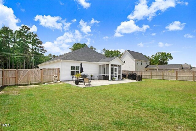607 Laurel Lake Rd, Salemburg, NC 28385 - rear view of house featuring a sunroom, a patio area, and a gate