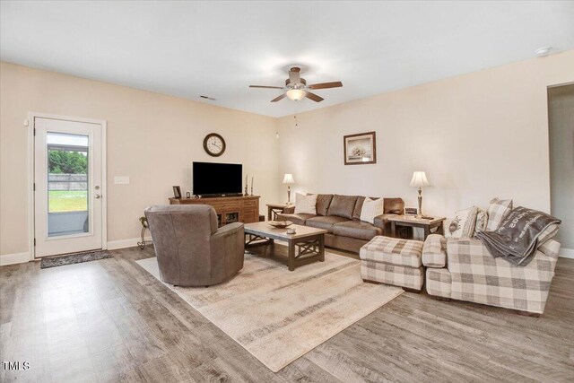 607 Laurel Lake Rd, Salemburg, NC 28385 - living area with wood finished floors, a ceiling fan, and baseboards
