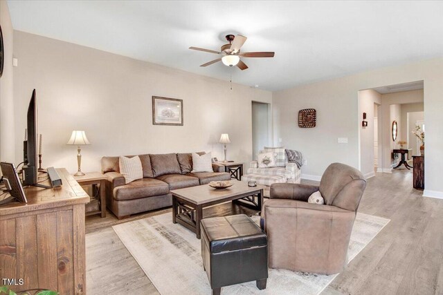 607 Laurel Lake Rd, Salemburg, NC 28385 - living room with light wood-style flooring, ceiling fan, and baseboards