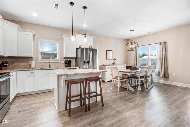 607 Laurel Lake Rd, Salemburg, NC 28385 - kitchen with stainless steel appliances, a sink, healthy amount of natural light, decorative backsplash, and recessed lighting