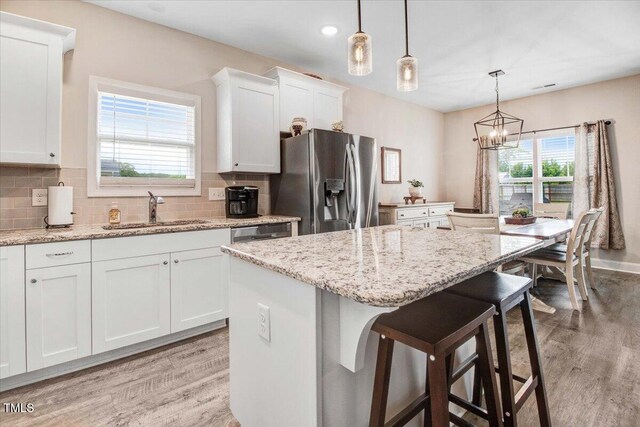 607 Laurel Lake Rd, Salemburg, NC 28385 - kitchen with a sink, appliances with stainless steel finishes, light wood finished floors, a center island, and recessed lighting