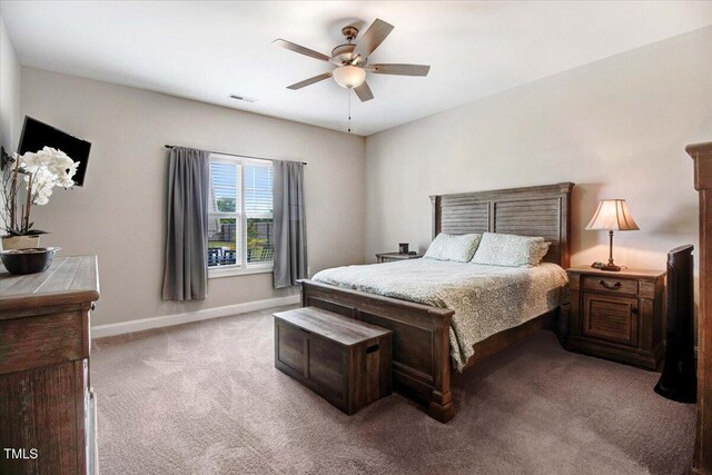 607 Laurel Lake Rd, Salemburg, NC 28385 - bedroom with light carpet, baseboards, and ceiling fan