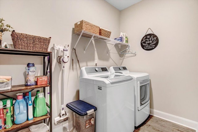 607 Laurel Lake Rd, Salemburg, NC 28385 - washroom with washer and clothes dryer, baseboards, and wood finished floors
