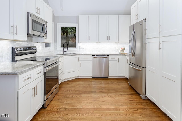 123 Becket Bnd, Pittsboro, NC 27312 - kitchen featuring appliances with stainless steel finishes, a sink, decorative backsplash, and white cabinetry