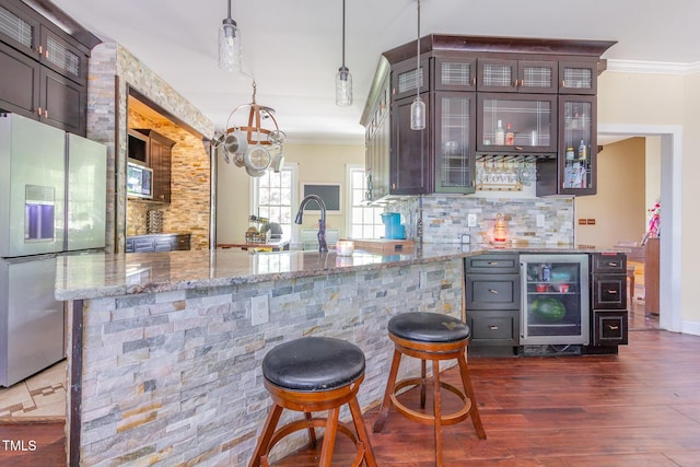 1770 Gentry Ridge Rd, Roxboro, NC 27574 - bar featuring stainless steel appliances, crown molding, beverage cooler, tasteful backsplash, and dark wood-type flooring