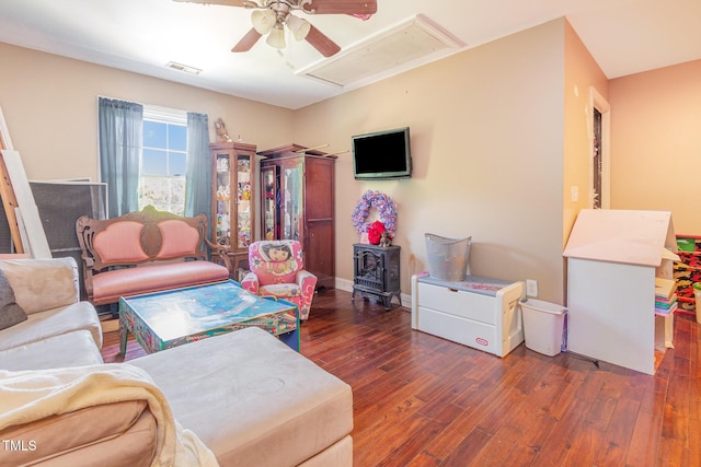 1770 Gentry Ridge Rd, Roxboro, NC 27574 - living room with attic access, hardwood / wood-style floors, ceiling fan, and a wood stove