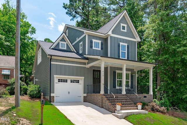 415 1st St, Apex, NC 27502 - craftsman house with board and batten siding, covered porch, driveway, a shingled roof, and a garage