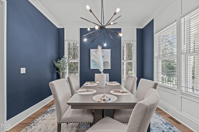 415 1st St, Apex, NC 27502 - dining area featuring a chandelier, ornamental molding, wood finished floors, and baseboards