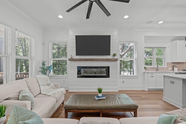415 1st St, Apex, NC 27502 - living area featuring ornamental molding, a fireplace, a ceiling fan, light wood finished floors, and recessed lighting