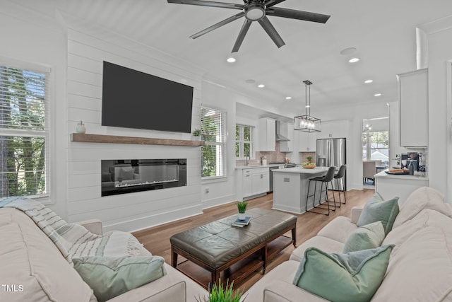 415 1st St, Apex, NC 27502 - living area with a ceiling fan, a large fireplace, light wood-type flooring, and recessed lighting