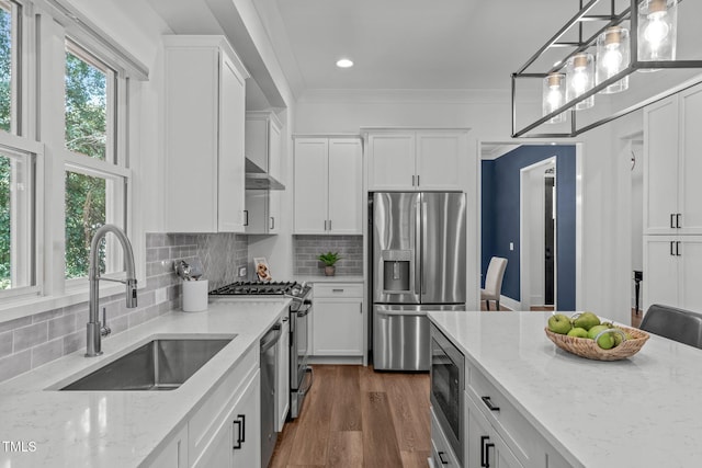 415 1st St, Apex, NC 27502 - kitchen featuring appliances with stainless steel finishes, a sink, white cabinetry, light stone countertops, and recessed lighting
