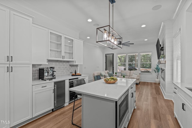 415 1st St, Apex, NC 27502 - kitchen with wine cooler, open floor plan, recessed lighting, white cabinetry, and decorative backsplash