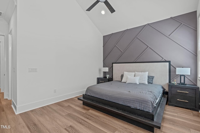 415 1st St, Apex, NC 27502 - bedroom with a decorative wall, light wood-style flooring, lofted ceiling, baseboards, and ceiling fan