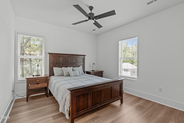 415 1st St, Apex, NC 27502 - bedroom featuring light wood-type flooring, baseboards, and ceiling fan