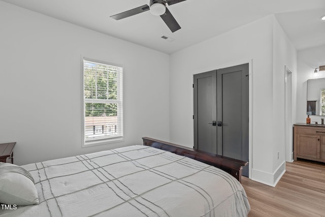 415 1st St, Apex, NC 27502 - bedroom with light wood-type flooring, baseboards, and a ceiling fan