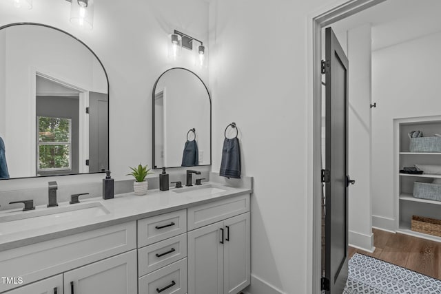 415 1st St, Apex, NC 27502 - bathroom featuring double vanity, wood finished floors, and baseboards