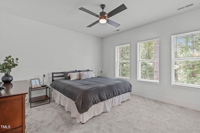 415 1st St, Apex, NC 27502 - bedroom featuring multiple windows, light colored carpet, baseboards, and ceiling fan