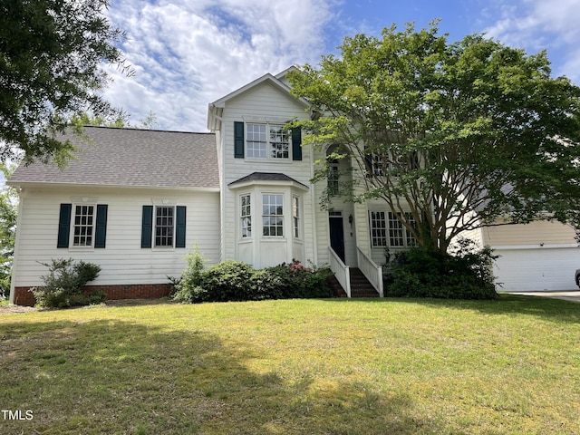 2208 Fieldmont Ct, Raleigh, NC 27614 - traditional-style house featuring a front yard, a garage, and a shingled roof