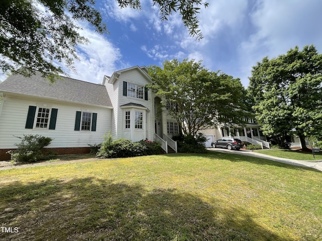 2208 Fieldmont Ct, Raleigh, NC 27614 - traditional-style house featuring a front lawn, roof with shingles, and driveway