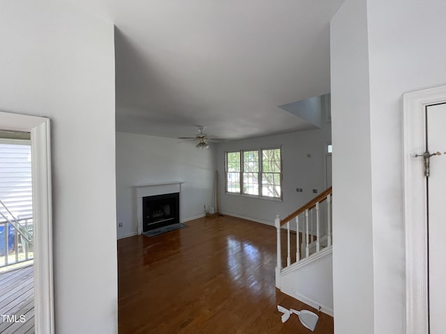 2208 Fieldmont Ct, Raleigh, NC 27614 - unfurnished living room with wood finished floors, a fireplace with flush hearth, baseboards, a ceiling fan, and stairway