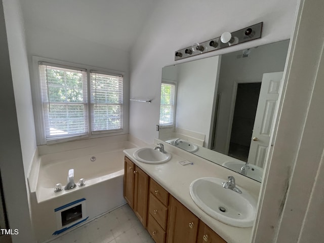 2208 Fieldmont Ct, Raleigh, NC 27614 - bathroom with double vanity, a garden tub, and vaulted ceiling