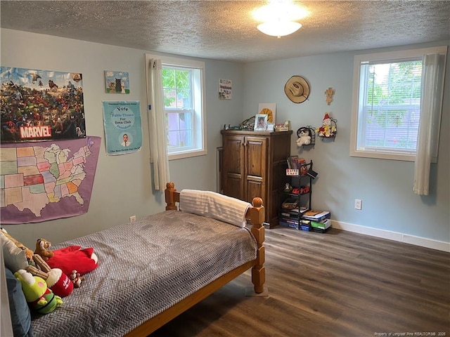 135 S Patterson S, Maxton, NC 28364 - bedroom with wood finished floors, a textured ceiling, and baseboards