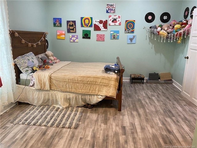 135 S Patterson S, Maxton, NC 28364 - bedroom featuring wood finished floors and baseboards