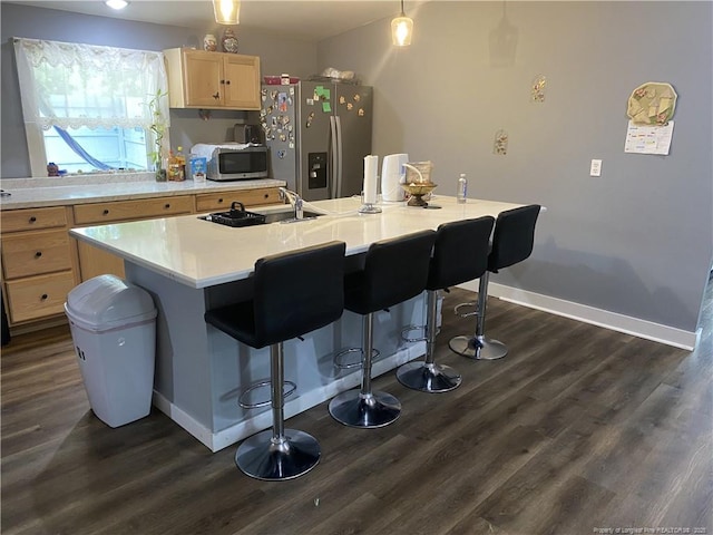 135 S Patterson S, Maxton, NC 28364 - kitchen with stainless steel appliances, light brown cabinetry, dark wood-style flooring, and light countertops