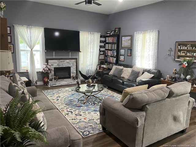 135 S Patterson S, Maxton, NC 28364 - living room featuring plenty of natural light, a ceiling fan, dark wood-style floors, and a fireplace