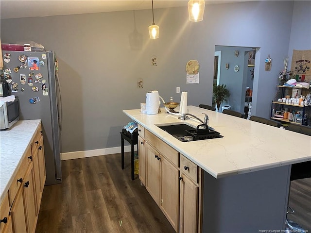 135 S Patterson S, Maxton, NC 28364 - kitchen featuring a sink, appliances with stainless steel finishes, dark wood-style floors, a kitchen bar, and a kitchen island with sink