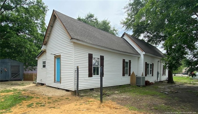 135 S Patterson S, Maxton, NC 28364 - view of side of property featuring crawl space, central AC unit, and a shingled roof