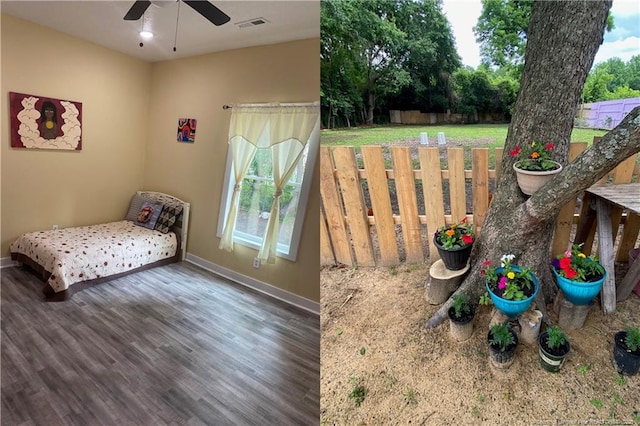 135 S Patterson S, Maxton, NC 28364 - bedroom featuring wood finished floors, baseboards, and multiple windows